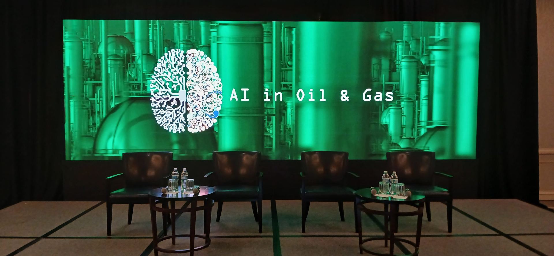 AI in Oil and Gas Conference 2024 panel stage with a full-width LED backdrop at DoubleTree Greenway Plaza, Houston