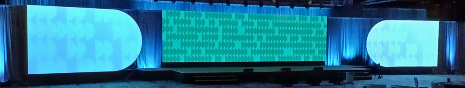 Avalara CRUSH 2024 general session stage with a 12 by 43 foot LED wall flanked by half-pill scenic projection surfaces at Fairmont Austin