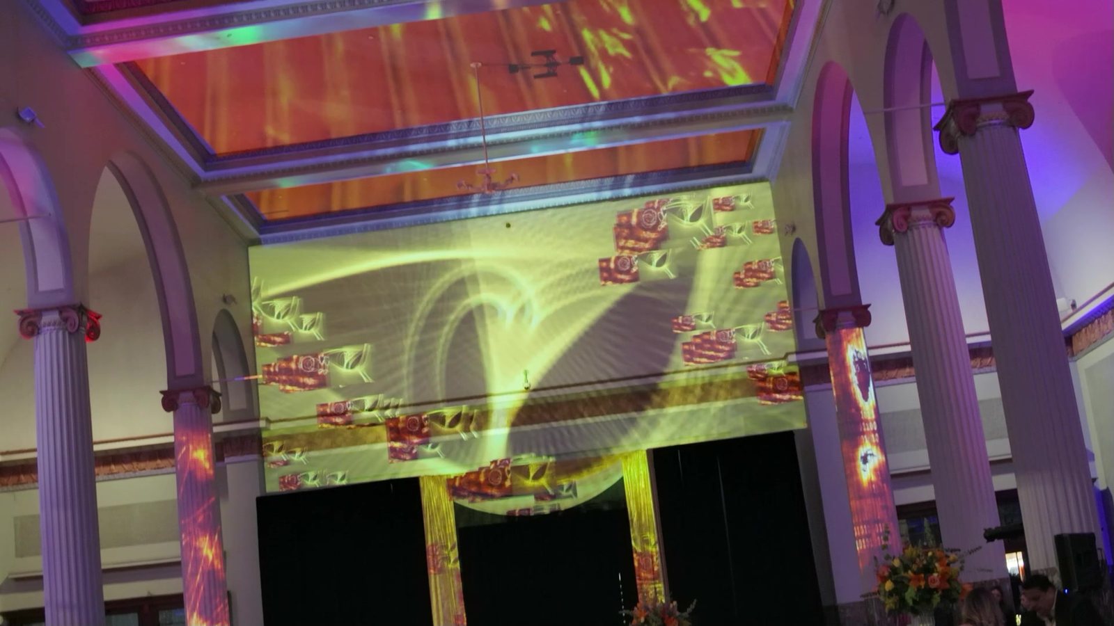Orange ceiling wash, event sneaker graphics mapped to the back wall and red textures on the columns at Historic Union Station